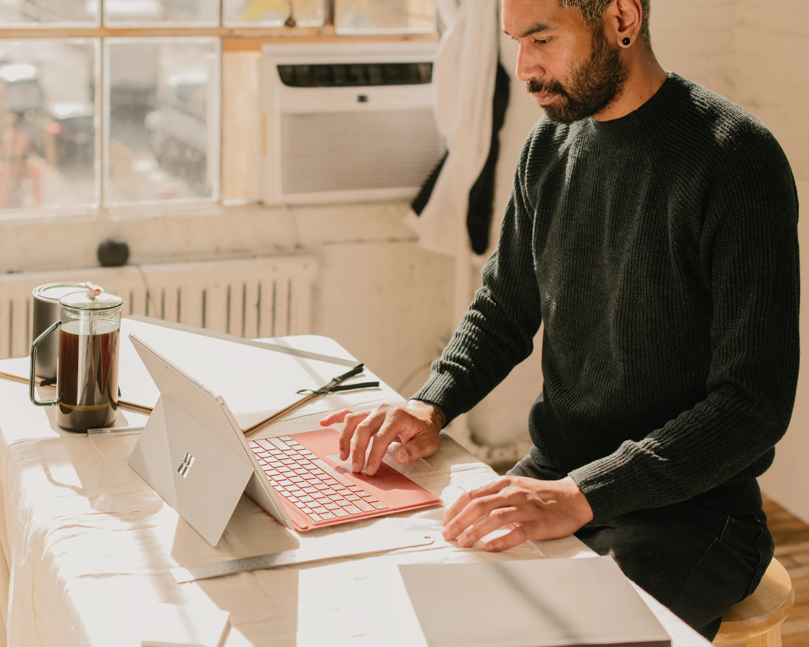 Owner of a small service business working at a laptop